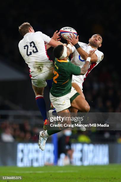 Max Malins and Joe Marchant of England compete with Elton Jantjies of South Africa for a high ball during the Autumn Nations Series match between...