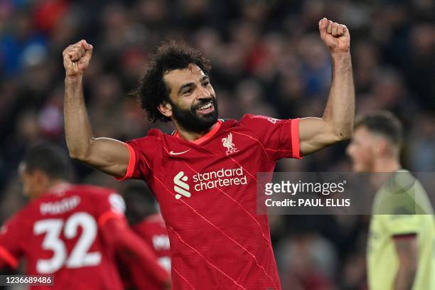 Liverpool's Egyptian midfielder Mohamed Salah celebrates scoring their third goal during the English Premier League football match between Liverpool...