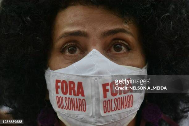 Woman wears a face mask that reads "Bolsonaro out" during a demonstration against racism on Black Consciousness Day in Sao Paulo, Brazil, on November...