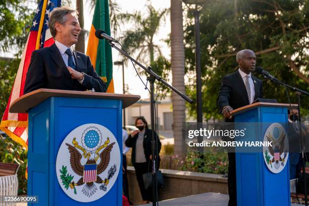 Secretary of State Antony Blinken laughs as he is introduced by US Ambassador to Senegal Tulinabo Mushingi as he greets employees and their families...