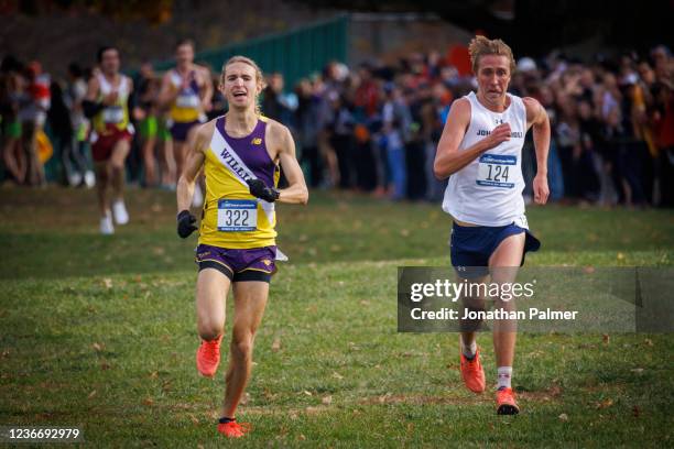 John Carroll sophomore Alex Phillip, center, won the individual championship, winning the 8K race with a time of 23:27.6 at the Division III Mens...