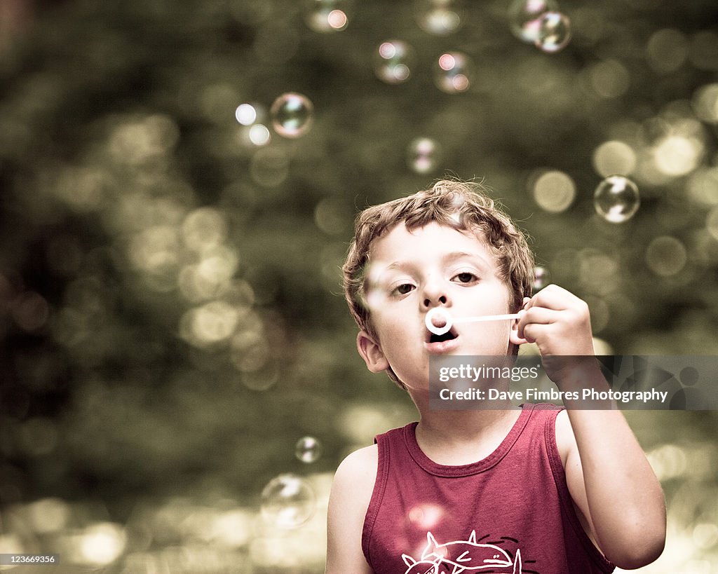 Boy blowing bubbles