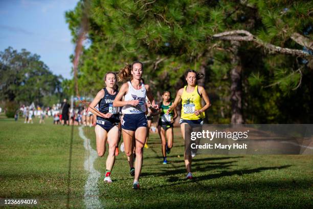 Celine Ritter of Lee leads Lara Orrock of Wingate and Megan Means of Augustana during the Division II Womens Cross Country Championship held at the...