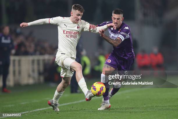 Cristiano Biraghi of ACF Fiorentina battles for the ball with Alexis Saelemaekers of AC Milan during the Serie A match between ACF Fiorentina and AC...