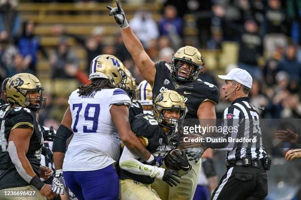 Linebacker Robert Barnes and defensive lineman Jalen Sami of the Colorado Buffaloes celebrate after a fumble recovery and turnover in the fourth...