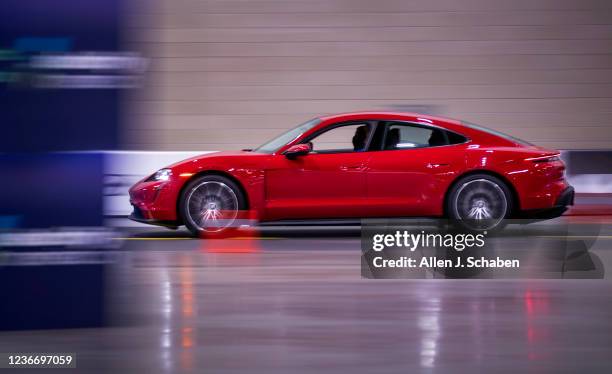 Los Angeles, CA Automotive enthusiasts test drive a Porsche Taycan electric sports car during the LA Auto Shows opening day at Los Angeles Convention...