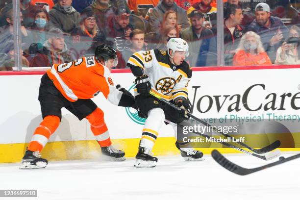 Brad Marchand of the Boston Bruins controls the puck against Travis Sanheim of the Philadelphia Flyers in the first period at the Wells Fargo Center...