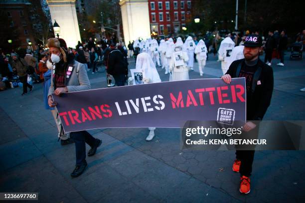 People hold a "Trans Life Matter" banner as they march, honoring transgender victims, killed for who they are, during the Transgender Day of...