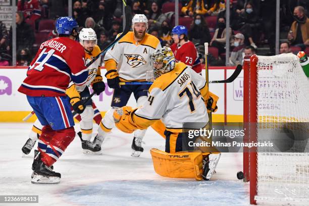 Brendan Gallagher of the Montreal Canadiens scores on goaltender Juuse Saros of the Nashville Predators during the second period at Centre Bell on...