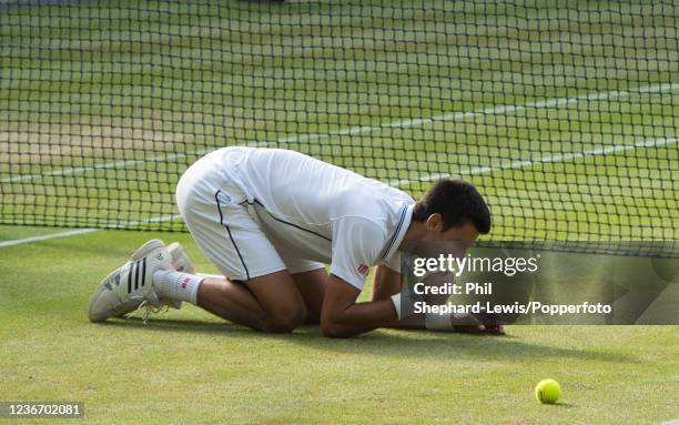 Novak Djokovic of Serbia reacts after defeating Roger Federer of Switzerland in the men's singles final during day thirteen of the 2014 Wimbledon...