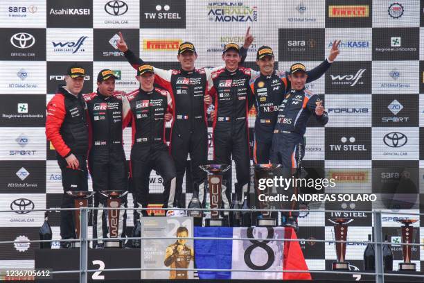 France's Sebastien Ogier celebrates his 8th World title with co-driver France's Julien Ingrassia on the podium, with runner-up Britain's Elfyn Evans...