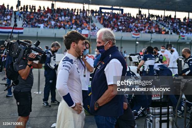 AlphaTauri's French driver Pierre Gasly speaks with Red Bull Formula One team advisor Helmut Marko ahead of the Qatari Formula One Grand Prix at the...