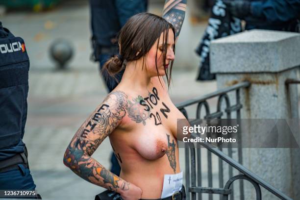 Image contains nudity) Femen activist with a 20N painted in her breast, rise her arm protesting against the fascism during a commemoration for the...