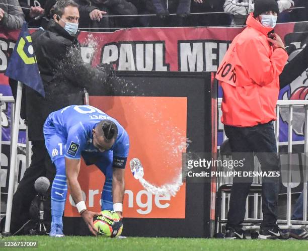 Marseille's French midfielder Dimitri Payet receives a bottle of water from the grandstand during the French L1 football match between Olympique...