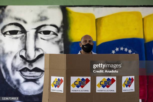 Man casts his vote at the polling station during the regional and local elections in Caracas, Venezuela, on November 21, 2021. More than 20 million...