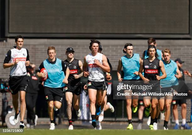 Players warm up during the Collingwood Magpies training session at Olympic Park Oval on November 22, 2021 in Melbourne, Australia.