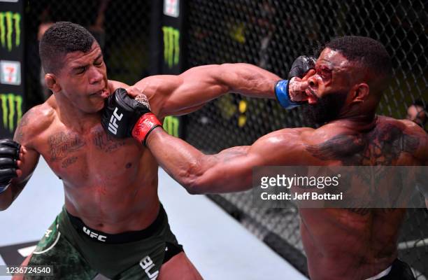 Gilbert Burns of Brazil and Tyron Woodley trade punches in their welterweight fight during the UFC Fight Night event at UFC APEX on May 30, 2020 in...