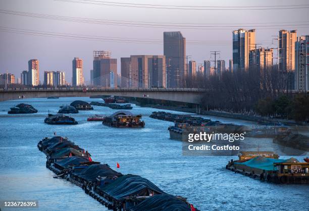 Coal ships carry coal on the Beijing-Hangzhou Grand Canal in Huai 'an, Jiangsu Province, China, Nov 22, 2021. Cold wave hit, in order to ensure power...