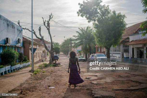 Woman walks through the city centre of Bissau on November 18, 2021.