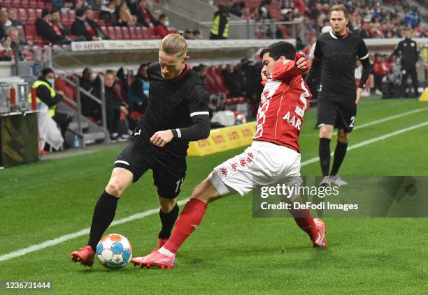 Florian Kainz of 1. FC Koeln and Aaron Martin of 1. FSV Mainz 05 battle for the ball during the Bundesliga match between 1. FSV Mainz 05 and 1. FC...
