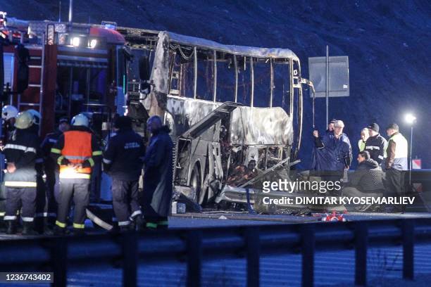 Officials work at the site of a bus accident, in which at least 45 people were killed, on a highway near the village of Bosnek, south of Sofia, on...