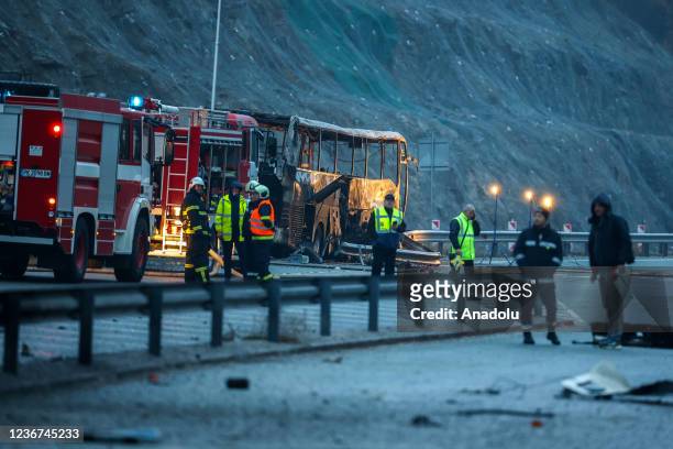 Officials work on the site, where 45 people were killed when a bus with North Macedonian plates caught fire on a highway, near the village of Bosnek...