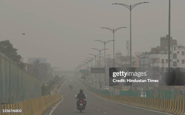 Vehicles ply on a road amid low visibility due to smog at Atal Path, on November 20, 2021 in Patna, India.