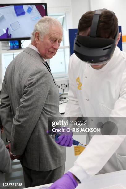 Britain's Prince Charles, Prince of Wales gets a demonstration of how augmented reality helps with Hololens technology during a visit to AstraZeneca...