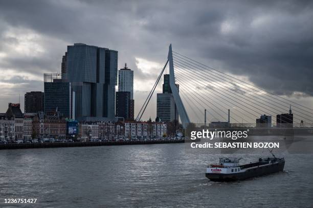 Barge cruises on the Nieuwe Maas near the Erasmus bridge in Rotterdam, western Netherlands, on November 23, 2021.