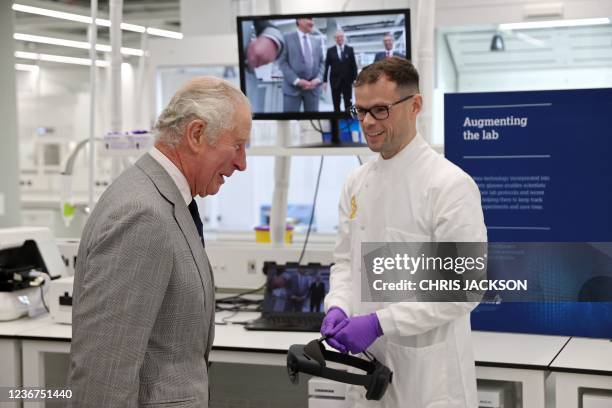 Britain's Prince Charles, Prince of Wales gets a demonstration of how augmented reality helps with Hololens technology during a visit to AstraZeneca...