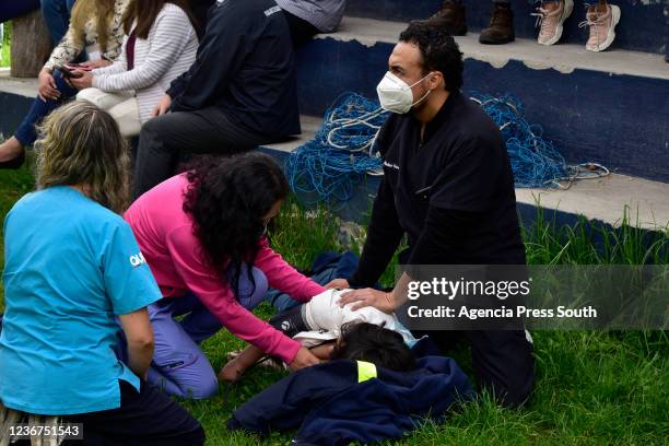 Doctors treat a woman after a magnitude 4.8 quake on November 23, 2021 in Quito, Ecuador. The quake's epicenter was located northeast of Quito and no...