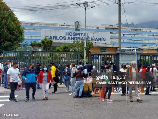 Medical personnel and patients are seen outside a public hospital after evacuating it due to a 4.5 degree quake in Quito, on November 23, 2021.