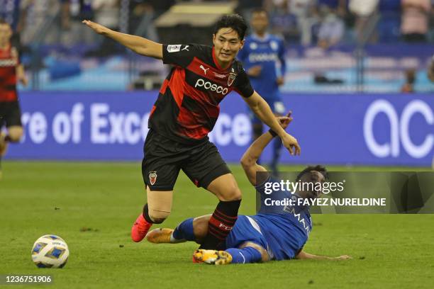 Hilal's midfielder Salem al-Dawsari vies for the ball with Pohang's defender Gwon Wan-gyu during AFC Champions League final football match between...