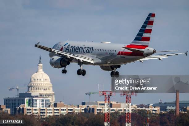 An American Airlines plane lands at Ronald Reagan Washington National Airport November 23, 2021 in Arlington, Virginia. With Covid-19 vaccinations on...