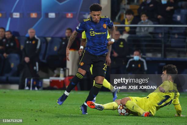 Manchester United's English midfielder Sancho vies with Villarreal's Spanish midfielder Manuel Trigueros during the UEFA Champions League Group F...