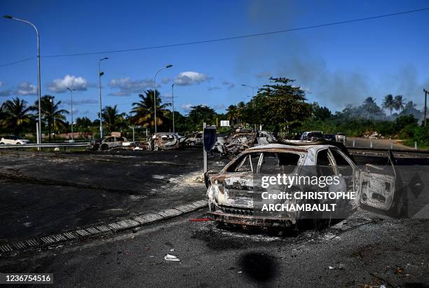 This photograph taken on November 23, 2021 shows barricades made of burnt cars at Montebello roundabout in Petit-Bourg, on the French Caribbean...