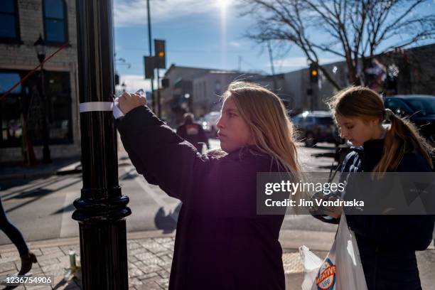 Memorials placed along Main Street in downtown Waukesha Wisconsin left in areas where people were hit by a driver plowing into the Christmas parade...