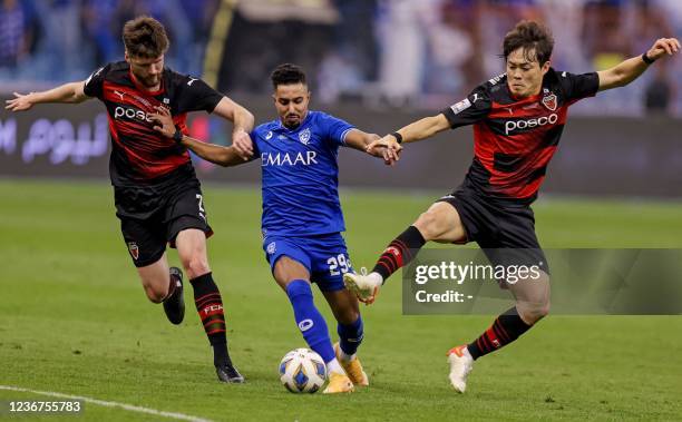 Hilal's midfielder Salem al-Dawsari vies for the ball with Pohang's defender Alex Grant and Pohang's defender Shin Kwang-hoon the AFC Champions...