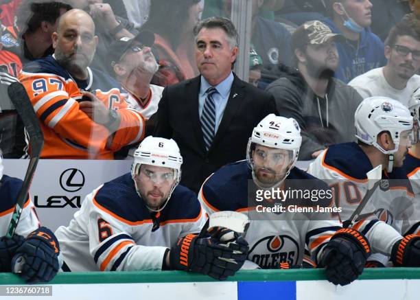 Dave Tippett of the Edmonton Oilers watches the action from behind the bench against the Dallas Stars at the American Airlines Center on November 23,...