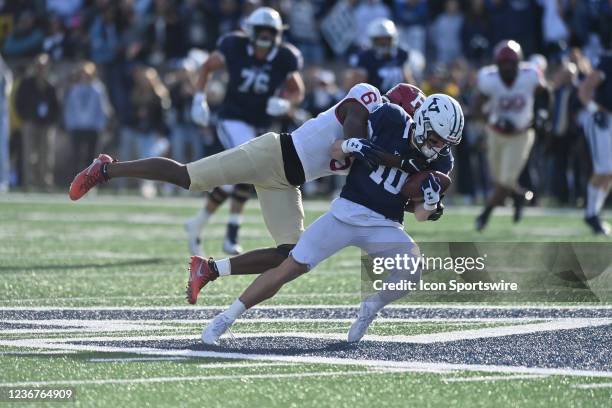 Harvard Crimson defensive back Khalid Thomas tackles Yale Bulldogs wide receiver David Pantelis during the game as the Harvard Crimson take on the...