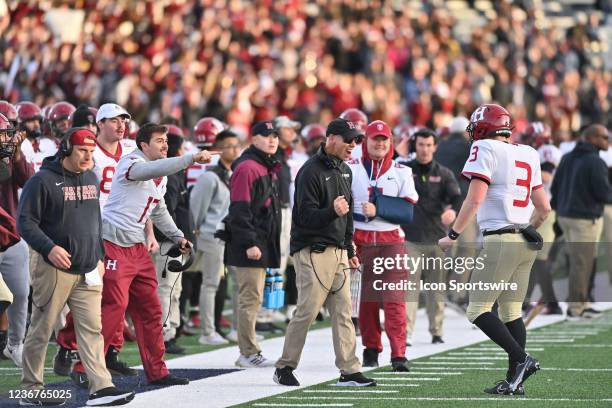 Harvard Crimson assistant head coach Joel Lamb cheers the team on during the game as the Harvard Crimson take on the Yale Bulldogs on November 20 at...