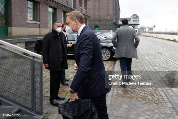 Christian Linder of the German Free Democrats arrives to hold up the mutually-agreed on coalition contract with the Greens and SPD on November 24,...
