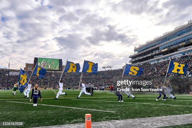 Notre Dame Fighting Irish cheerleaders celebrate with Notre Dame Fighting Irish flags after a touchdown play during a game between the Notre Dame...