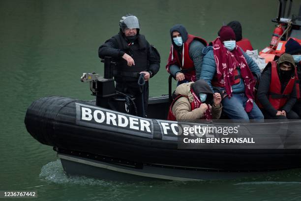 Border Force patrol boat carries migrants picked up at sea on arrival at the Marina in Dover, southeast England, on November 24, 2021. - The past...