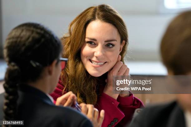 Britain's Catherine, Duchess of Cambridge listens to students during a visit to Nower Hill High School on November 24, 2021 in London, England....