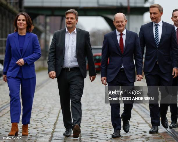 The co-leaders of Germany's Greens party Annalena Baerbock and Robert Habeck, the Social Democrats candidate for Chancellor Olaf Scholz and Germany's...