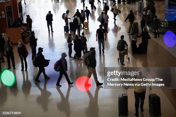 November 23: Holiday lights are on display as travelers walk inside Norman Y. Mineta San Jose International Airport on Tuesday, Nov. 23 in San Jose,...