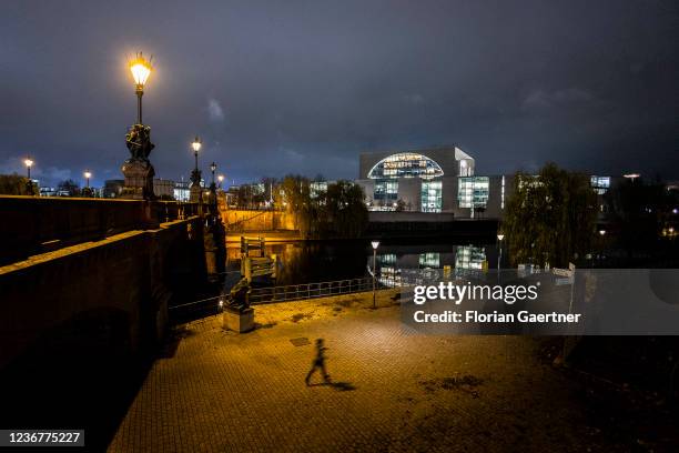 Jogger is pictured in front of the Federal Chancellery at night on November 24, 2021 in Berlin, Germany.