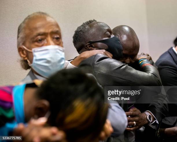 Ahmaud Arbery's father Marcus Arbery, center, his hugged by his attorney Benjamin Crump after the jury convicted Travis McMichael in the Glynn County...