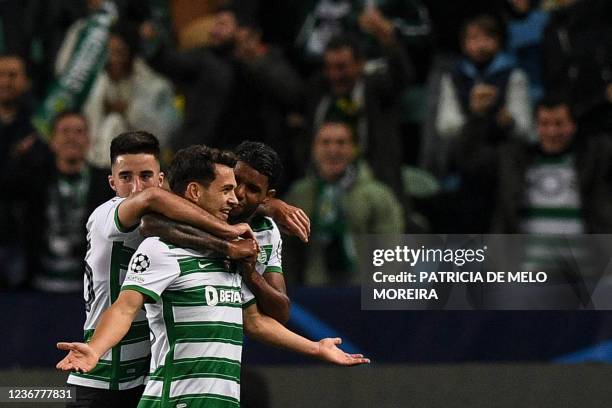 Sporting Lisbon's Portuguese midfielder Pedro Goncalves celebrates with teammates scoring his team's second goal during the UEFA Champions League...